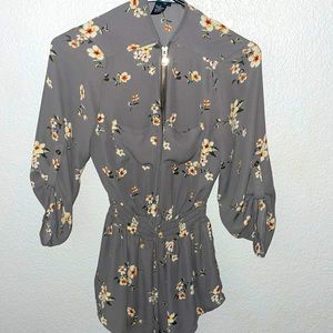 This is a very cute blouse, it has a very flattering cinched waist thing